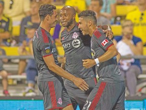 Toronto FC midfielder Jonathan Osorio (right) celebrates his goal against Columbus with Gilberto (left) and Collen Warner. (USA TODAY SPORTS)