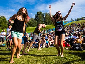 People dance during a set at the Edmonton Folk Music Festival on Sunday. (CODIE MCLACHLAN/EDMONTON SUN)
