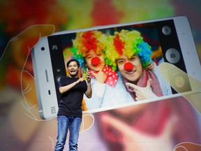 Lei Jun, founder and chief executive officer of China's mobile company Xiaomi, demonstrates the new features of the new Xiaomi Phone 4 at its launching ceremony, in Beijing July 22, 2014. REUTERS/Jason Lee