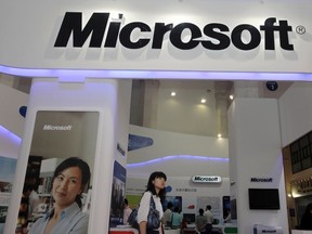 A visitor walks past a Microsoft booth at a computer software expo in Beijing, in this June 2, 2010 file photo. REUTERS/Stringer/Files