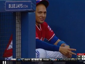 Second baseman Ryan Goins makes goes for "scissors" in the Jays dugout on Sunday.