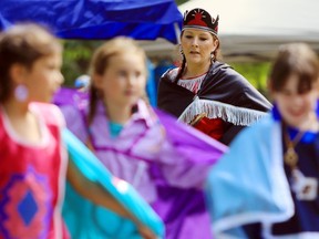 Belleville's Amanda Boomhour dances behind a group of girls at the Tyendinaga Mohawk Pow Wow Saturday at Tsi Tkerhitoton Park.