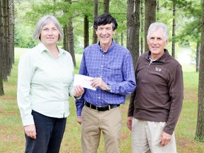 Kate Monk, on behalf of Carbon Footprints to Forests, receives a cheque from the Rotary Club of Grand Bend, presented by Max Morden, a Rotarian and Climate Reality Presenter, and Tom Prout, past chair of Grand Bend Community Foundation and moderator at the event.