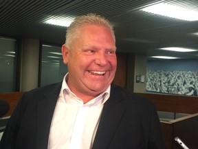 Councillor Doug Ford speaks to reporters at City Hall in Toronto on Monday, August 11, 2014. (Don Peat/Toronto Sun)
