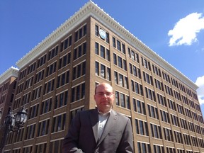 Elliot Sims of the Canadian Federation of Independent Business stands outside the downtown headquarters of Manitoba Public Insurance. (David Larkins/Winnipeg Sun)