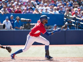Toronto Blue Jays shortstop Jose Reyes (7) hits a single during the seventh inning in a game against the Detroit Tigers at Rogers Centre on Aug. 10, 2014. (NICK TURCHIARO/USA TODAY Sports)