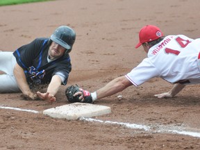 Jake Walkom (left) of the Mitchell Mets slides safely into third base just eluding the tag of Troy Barfoot of the Wiarton Nationals during action from the International Softball Congress (ISC) World Championship tournament in Budd Park in Kitchener on Monday, Aug. 11, 2014. Mitchell defeated Wiarton 10-1. ANDY BADER/MITCHELL ADVOCATE