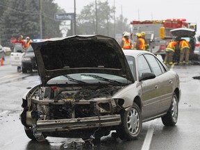 Members of Quinte West, Ont. OPP and Fire Department respond to a two-vehicle collision on Old Highway 2, west of Bayside, Ont. mid-morning Tuesday, Aug. 12, 2014.  - Jerome Lessard/The Intelligencer