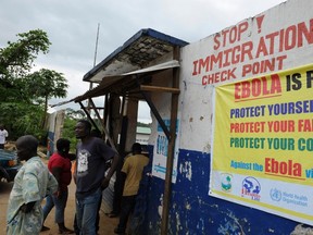 Liberian soldiers check people travelling in Bomi County August 11, 2014. Liberian troops set up Ebola roadblocks and stopped public access to some of the worst-hit towns after the country declared a state of emergency to tackle the worst outbreak of the disease on record. REUTERS/Stringer