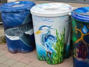 Three painted rain barrels that are being auctioned off this month sit outside the Sustainable Kingston office. (Alex Pickering/For The Whig-Standard)