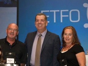 Roger and Lynn Paquette, of Sarnia, receive a humanitarian award from Sam Hammond, president of the Elementary Teachers' Federation of Ontario. Their daughter Noelle Paquette was recognized posthumously for her work helping students in need. Their charity Noelle's Gift was also honoured for continuing to provide necessities to students in their daughter's memory. (Submitted photo)