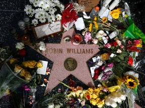 Flowers are seen on the late Robin Williams' star on the Hollywood Walk of Fame in Los Angeles, California August 12, 2014. REUTERS/Lucy Nicholson