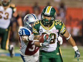 Esks running back Kendial Lawrence is chased by Alouettes Winston Venable during Friday's game in Montreal. (QMI Agency)