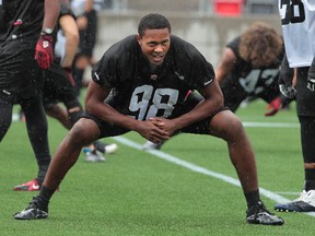 Ottawa RedBlacks defensive lineman Marlon Smith stretches during practice at TD Place on Tuesday. (Tony Caldwell/Ottawa Sun)