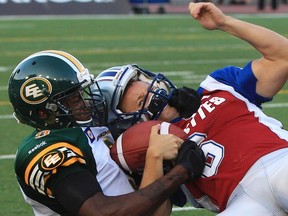 Eskimos CB Patrick Watkins tackles Alouettes Sean Whyte during Friday's game in Montreal. (Reuters)