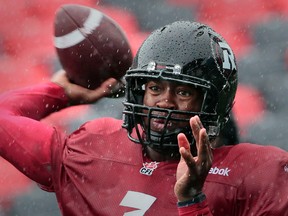 RedBlacks QB Henry Burris is drenched by the rain in Ottawa during practice Tuesday at that team's facility, while the Eskimos faced the same conditions at their practice field in Gatineau across the river. (QMI Agency)