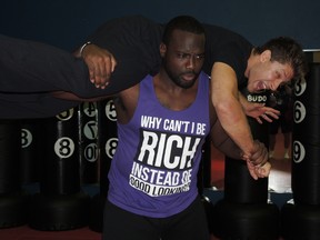 RedBlacks offensive lineman J’Micheal Deane learned and performed a stunt routine with actor/stuntman Alain Moussi Tuesday at NX Martial Arts and Fitness in Orléans.(Tim Baines/Ottawa Sun)