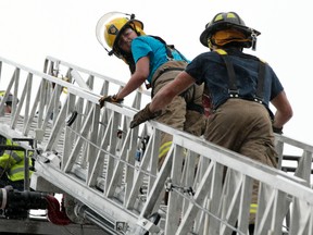 A week-long firefighters camp for women is being held at the Ottawa Fire Services Training Division building this week. Camp FITT provides young women with an opportunity to experience first-hand what it takes to be a firefighter. Camp members are shown here climbimg a 90-foot ladder Tuesday, Aug. 12, 2014. 
Tony Caldwell/Ottawa Sun/QMI Agency