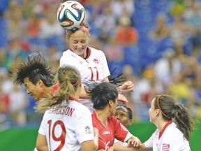 Canada’s Janine Beckie heads the ball away from a North Korean player last night in Montreal. (SEBASTIEN ST-JEAN/QMI Agency)
