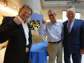 Canadian Olympic cycling medalist Curt Harnett (L) , Chris Taylor, a  cancer survivor, cyclist and inductee (Middle) and Paul Alofs, president and CEO of Princess Margaret Cancer foundation. (JACK BOLAND, Toronto Sun)