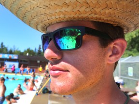 A lifeguard keeps a eye on swimmers at Millcreek Pool in Edmonton, Alberta on July 30, 2014. Perry Mah/Edmonton Sun