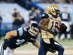 Winnipeg Blue Bombers returner Troy Stoudermire runs for daylight against linebacker Thomas Miles of the Toronto Argonauts during Toronto's 38-21 victory in CFL action at the Rogers Centre in Toronto, Ont. on Tuesday August 12, 2014. Stan Behal/Toronto Sun/QMI Agency