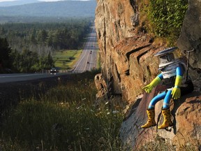 The hitchBOT is seen posed next to Highway 17 north of Sault Ste. Marie, Ontario, and a portion of the Trans-Canada Highway August 5, 2014. The hitch-hiking robot is now at the halfway point in its journey across Canada. Picture taken August 5, 2014. REUTERS/Kenneth Armstrong
