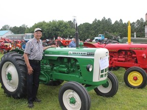 Bill Patterson of Dutton poses with his Oliver 500 and David Brown 950 which he says are essentially identical tractors.