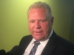 Councillor Doug Ford speaks to reporters on City Hall on Wednesday, Aug. 13, 2014. (DON PEAT/Toronto Sun)