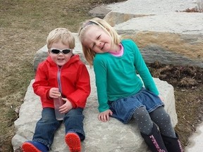 Everett Bovingdon sits on a rock with his sister Madeleine in this photo taken before the accident. (SUPPLIED)