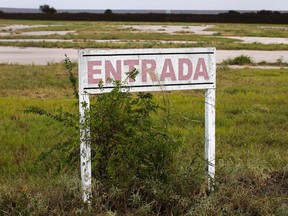An entrance sign written in Spanish is seen along the U.S.-Mexico border fence near Brownsville, Texas on August 4, 2014.  (REUTERS/Shannon Stapleton)
