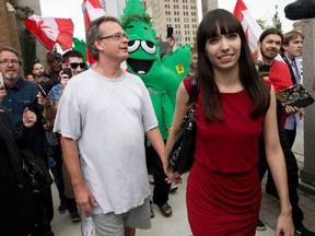 Pot activist Marc Emery walks down the street with his wife, Jodie, and supporters following his release from a U.S. federal prison, where he served four and a half years for selling marijuana seeds online, in Windsor, Ontario on Tuesday August 12, 2014.
CRAIG GLOVER/The London Free Press/QMI Agency