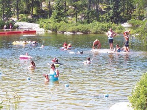 The popular swimming beach at Rushing River Provincial Park, near Kenora, Ont., was the scene of a dramatic life-saving rescue on Aug. 6, 2014. Three vacationing Winnipeggers pulled a man from the floor of the lake and performed CPR to revive him. (QMI Agency file photo)