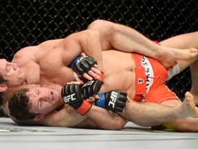Michael Bisping (red gloves) fights against Tim Kennedy (blue gloves) during their middleweight bout in Quebec City earlier this year. (Eric Bolte-USA TODAY Sports)