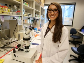 Grande Prairie Composite High School Grade 11 student Victoria Sajtovich, 17, poses in a lab at the Medical Sciences Building, 87 Avenue and 114 Street, at the University of Alberta in Edmonton, AB on August 12, 2014. Sajtovich is one of 22 students chosen to participate in the six-week Heritage Youth Researcher Summer (HYRS) program, which provides hands-on health research experiences in laboratories and clinics at the U of A. TREVOR ROBB/Edmonton Sun/QMI Agency
