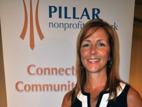 Michelle Baldwin, executive director of Pillar Nonprofit, stands with a picture of 201 King Street during a news conference at Goodwill Industries in London, Ontario August 13, 2014. Pillar announced it has purchased the building (currently the headquarters of Goodlife) and will use it to create a new Social Innovation Shared Space with partners Emerging Leaders, London Arts Council and London Heritage Council. CHRIS MONTANINI\LONDONER\QMI AGENCY