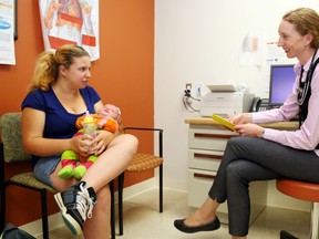 Justine Faragher holds her daughter, Karlee, during a checkup with Dr. Ciara Brown at the health centre.