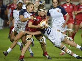 Canadian prop Marie-Pier Pinault-Reid (centre) fights with France players during the Women's Rugby World Cup semifinal at the Jean Bouin Stadium on Wednesday, Aug. 13, 2014. (Fred Dufour/AFP)