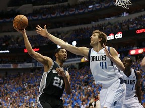 San Antonio Spurs forward Tim Duncan shoots against  Dallas Mavericks forward Dirk Nowitzki during Game 4 of the first round of the 2014 NBA Playoffs at American Airlines Center on April 28, 2014. (Matthew Emmons/USA TODAY Sports)