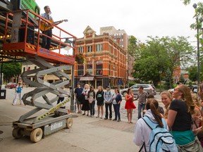 Canadian singer-songwriter Royal Wood performs on a scissor lift as a promotion in front of the Grand Theatre on Richmond Street in London on Wednesday. Mike Hensen/The London Free Press/QMI Agency