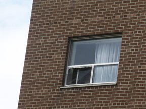 The fourth-floor window of a Mississauga apartment located near Cawthra Rd. and Lake Shore Blvd. E. from which a four-year-old girl fell on Wednesday, August 13, 2014. (Jack Boland/Toronto Sun)