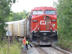 Officials at the scene of a fatal incident involving a CP freight train in Milton, Wednesday, Aug. 13, 2014. (Andrew Collins photo)