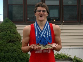 Gordie Michie stands outside his St. Thomas home with medals he won at the recent Para Pan Pacific Para-swimming championships in Pasadena, California. Michie won three gold medals and two bronze medals at the event. 

Ben Forrest/Times-Journal