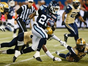 Curtis Steele carries the ball for the Argos as the Toronto Argonauts lead the Winnipeg Blue Bombers  21-14 after the first half of  CFL action at the Rogers Centre in Toronto, Ont. on Tuesday August 12, 2014. Stan Behal/Toronto Sun/QMI Agency