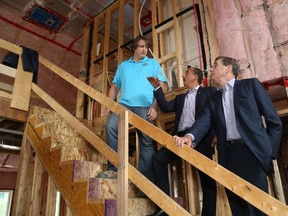 JOHN LAPPA/THE SUDBURY STAR/QMI AGENCYPhil Monkhouse, left, president of the Sudbury and District Home Builders' Association, Vince Molinaro, incoming president of the Ontario Home Builders' Association, and Howard Bogach, president and CEO of Tarion Warranty Corporation, held a press conference at a home under construction in Garson, ON. on Wednesday, August 13, 2014.