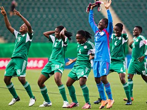 Nigerian players react after defeating England 2-1 during FIFA U-20 Women's World Cup action between Paraguay and England at Commonwealth Stadium in Edmonton, Alta., on Wednesday, Aug. 13, 2014. Codie McLachlan/Edmonton Sun/QMI Agency