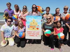 Ashley Tanguay is introducing Bluewater Beach Fest to Canatara Park's shores Aug. 23 and 24. The all-weekend festival will feature sandcastle building competitions, bands, vendors and kids' activities. Tanguay is pictured at the beach with friends, family and co-workers who are helping her get ready for the potentially annual event. (TYLER KULA, The Observer)