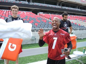 Ottawa RedBlacks quarterback Henry Burris reacts after getting two buckets of ice water dumped on him Thursday at TD Place. He answered a challenge by former teammate Andy Fantuz, then issued a challenge of his own - to CFL commissioner Mark Cohon and Prime Minister Stephen Harper. (TIM BAINES/Ottawa Sun)