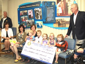 Children and adults alike celebrate a donation from the Rotary Club of Sarnia to Pathways Health Centre for Children in Sarnia on Thursday. Pathways offers a variety of services for children with physical, developmental and communication needs across Lambton County.
(CARL HNATYSHYN, QMI Agency)