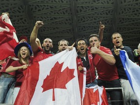 Canadian supporters react after their team won the IRB Women's Rugby World Cup semifinal match France vs Canada at the Jean Bouin Stadium, on August 13, 2014 in Paris. Canadian rugby fans in Sarnia will have their chance to cheer on a national team, as the 2014 Can/Am U20 series will feature a contest between the Canadian U20 and American U20 women's teams at Norm Perry Park on Saturday, Aug. 23. (AFP photo)